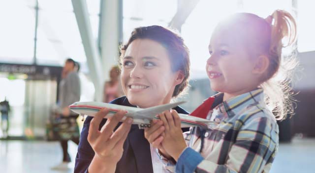 happy child and mom in airport without luggage