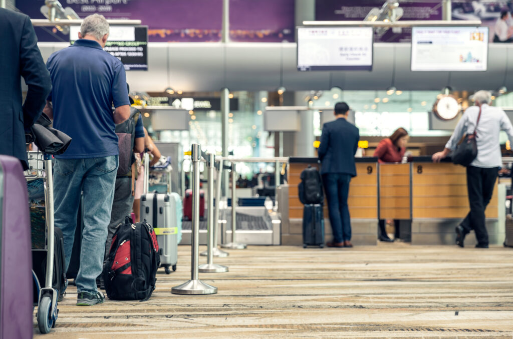 Customers standing in line to check their bags could save money by shipping their luggage instead